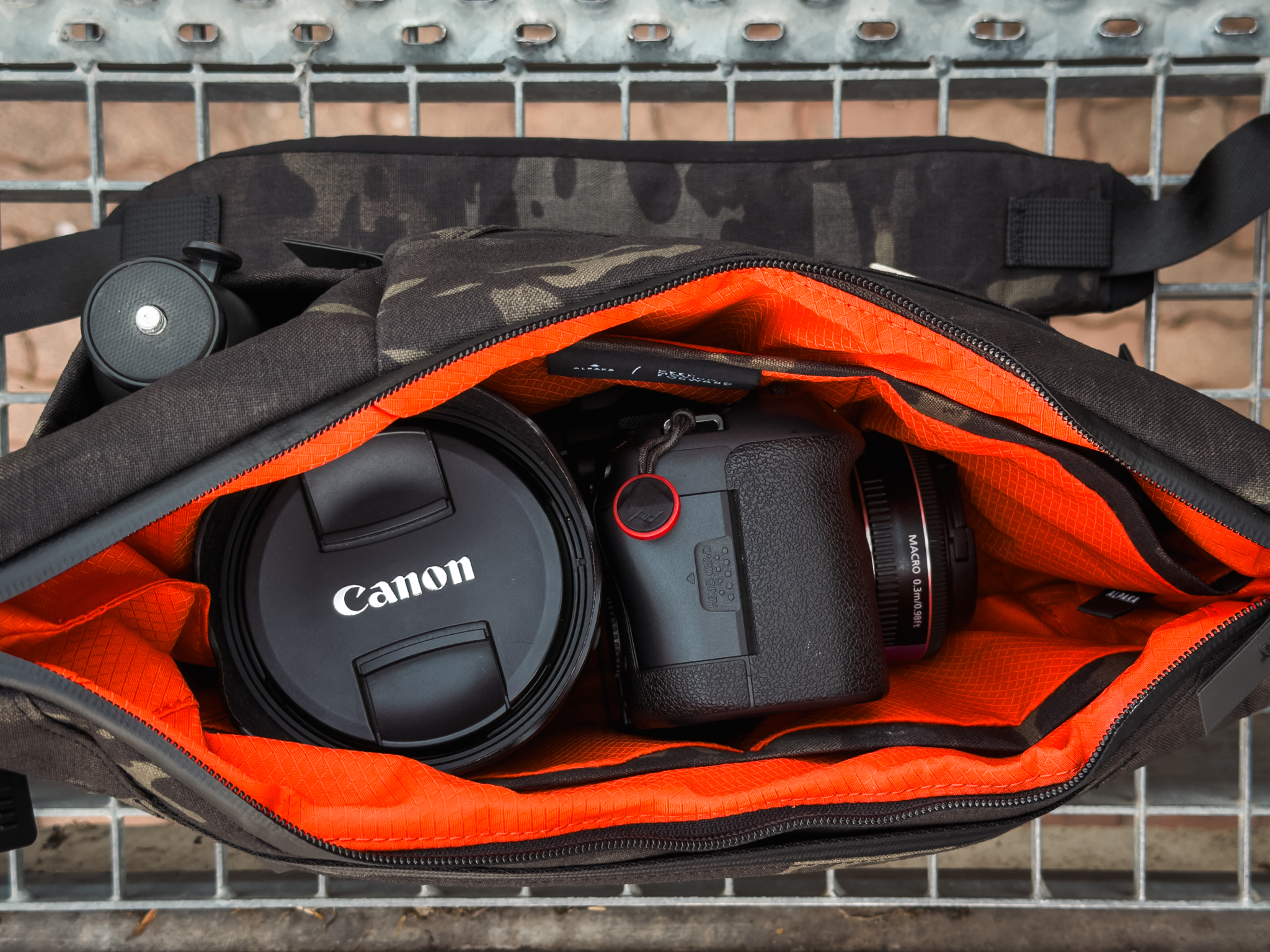 Orange main compartment holding a Canon R6 Mark II and a separate 24–70mm lens