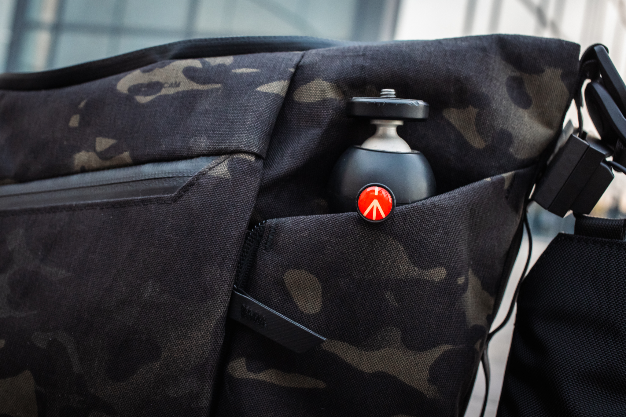 Small Manfrotto tripod in the Flow Satchel's expandable side sleeve