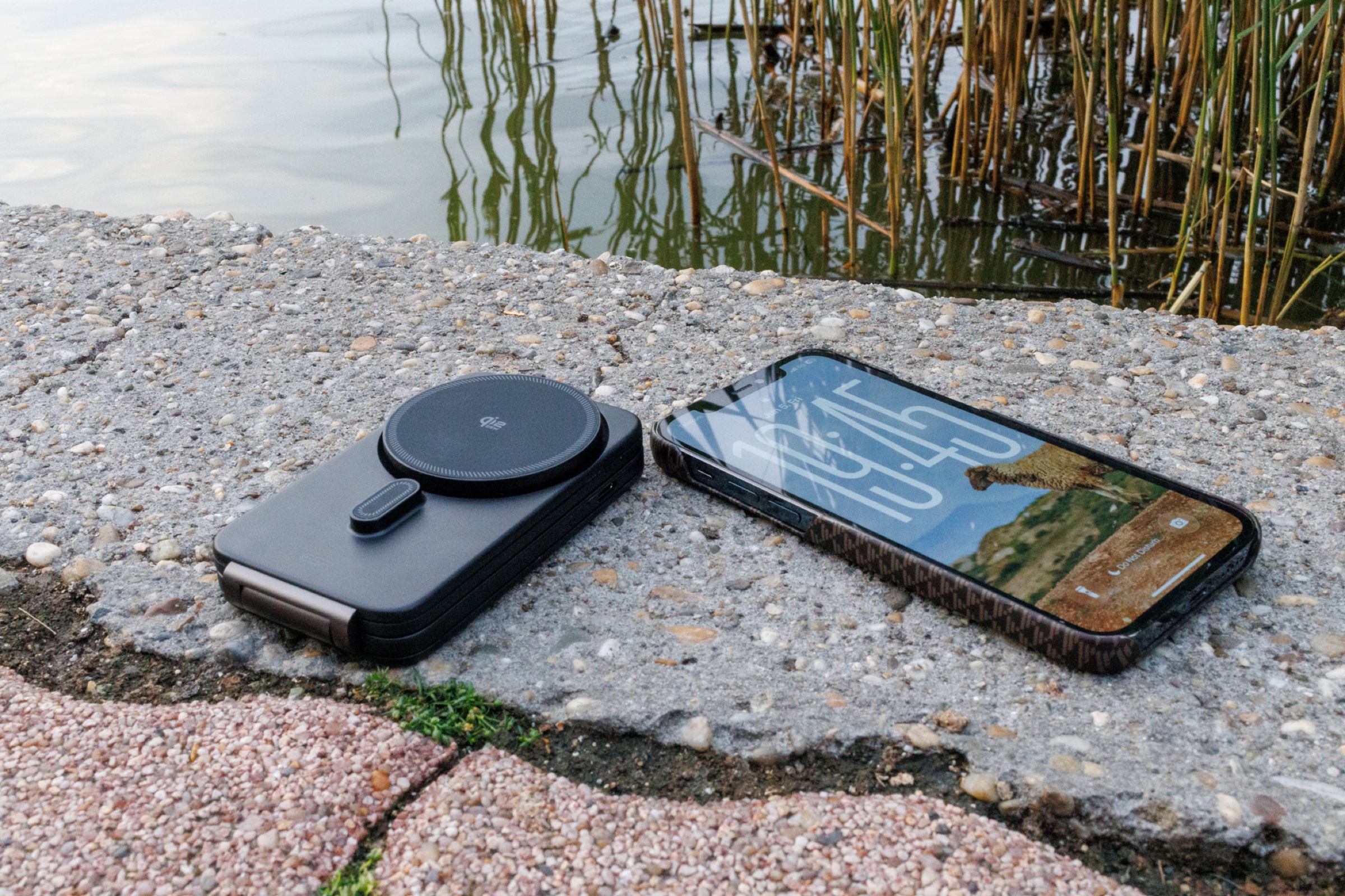 ESR CryoBoost charger and iPhone 12 Pro during a riverside charging test