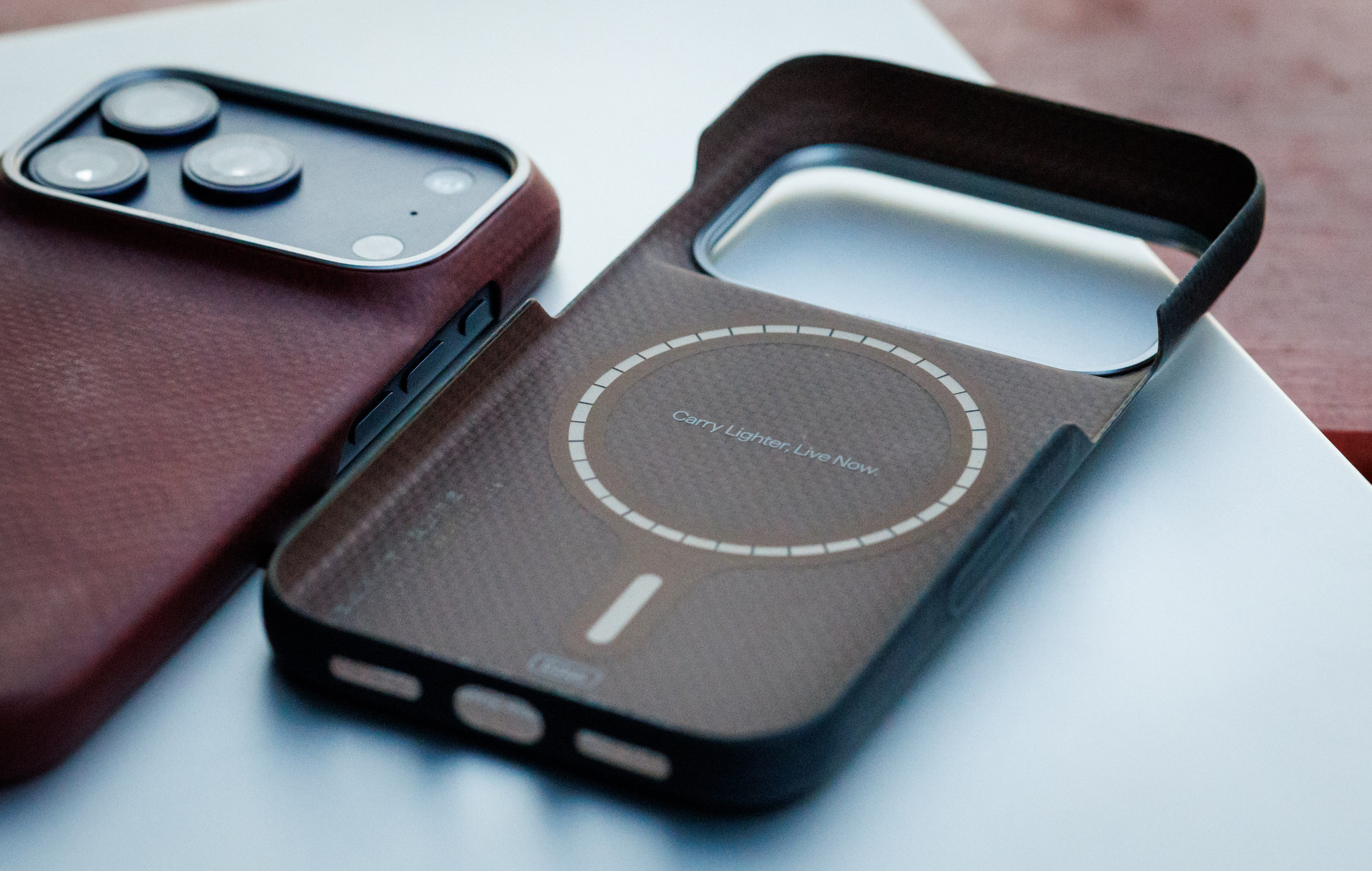 The magnetic ring inside a PITAKA case beside my cased iPhone